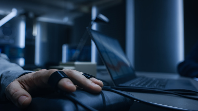 Close-up Shot of the Suspect's Hand Connected to the Lie Detector / Polygraph Test Machine, while Female Special Agent Conducts Questioning.