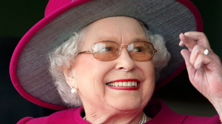 Queen Elizabeth II with fingers crossed
