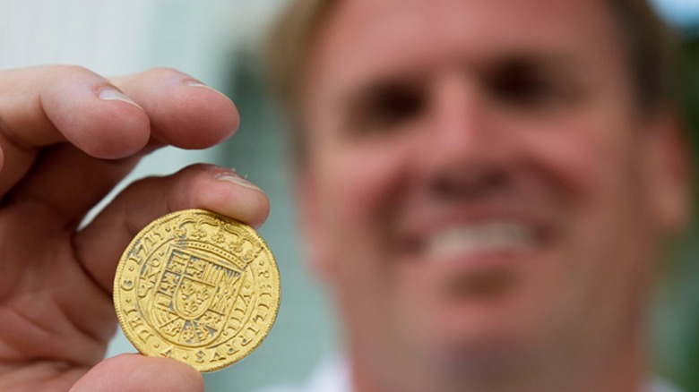 Brent Brisben holds gold coin