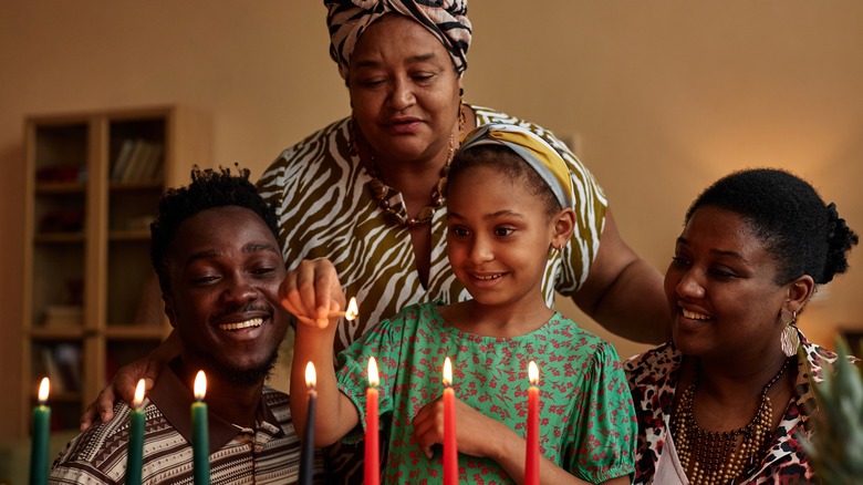 family lighting the candles for Kwanzaa