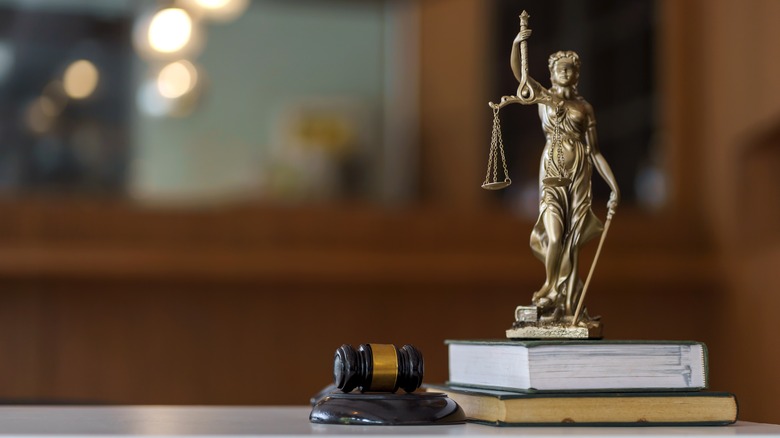Justice atop a book beside a gavel