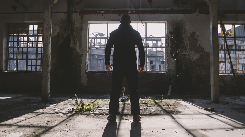 Killer standing in abandoned warehouse