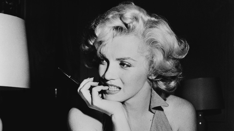 Marilyn Monroe posing with pen