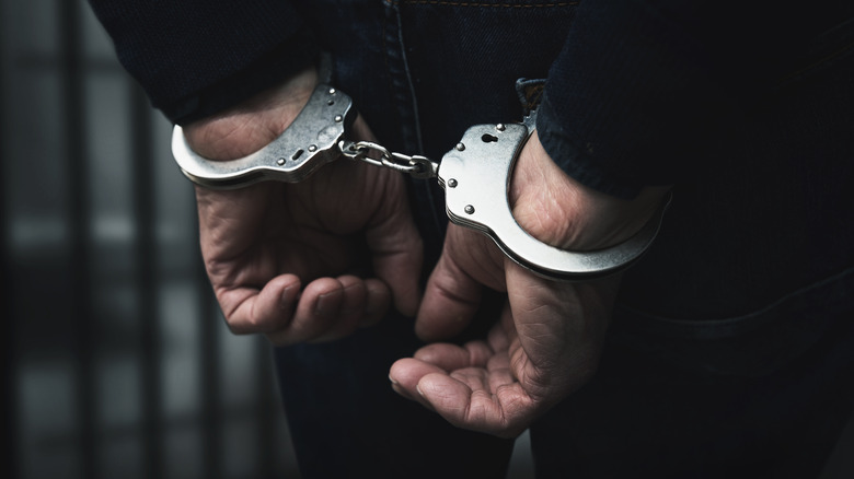 Man's hands handcuffed