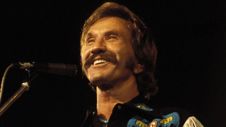Marty Robbins smiling on stage in western wear