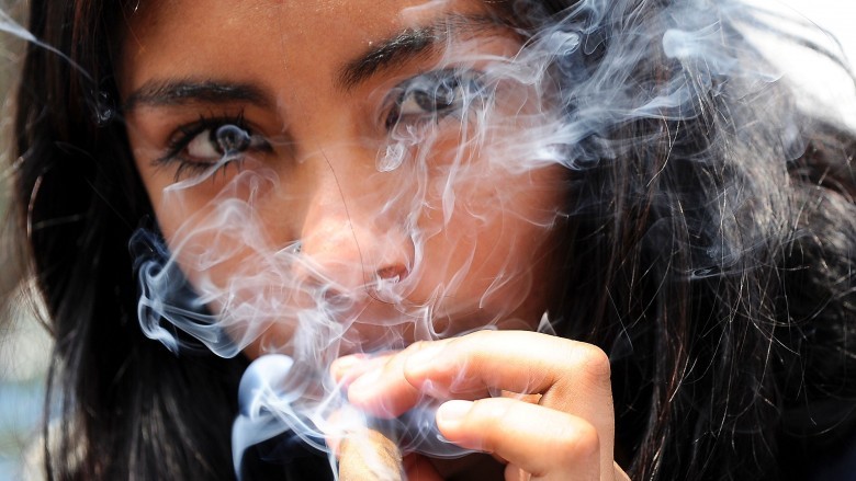 Woman smoking joint close up