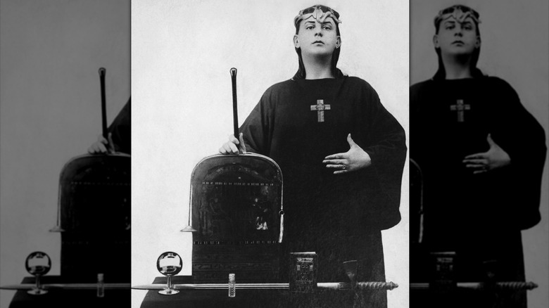 Aleister Crowley posing in magical garb