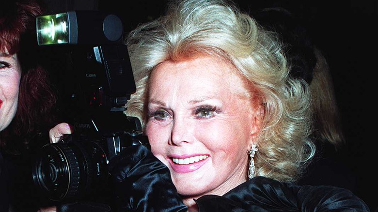 Zsa Zsa Gabor holding a camera