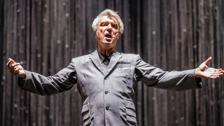 David Byrne singing and waving arms