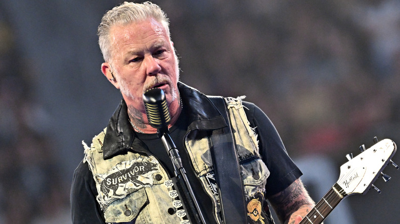 James Hetfield of Metallica playing guitar and singing onstage
