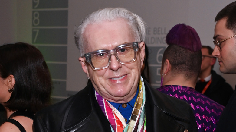 holly johnson cocked head with big glasses and scarf