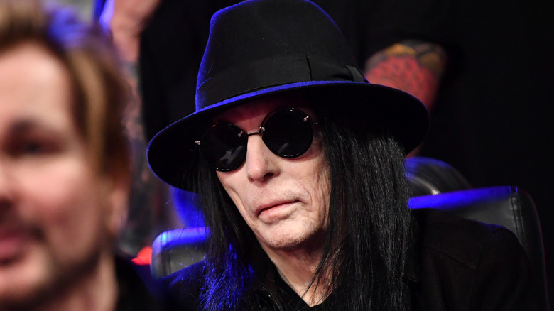 mick mars stoic in sunglasses and black hat