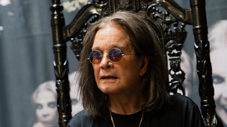 ozzy osbourne sitting in chair looking off to side