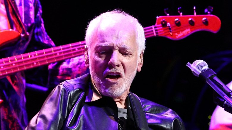 peter frampton making guitar face while playing onstage