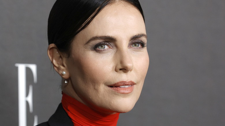 Charlize Theron with dark hair on the red carpet