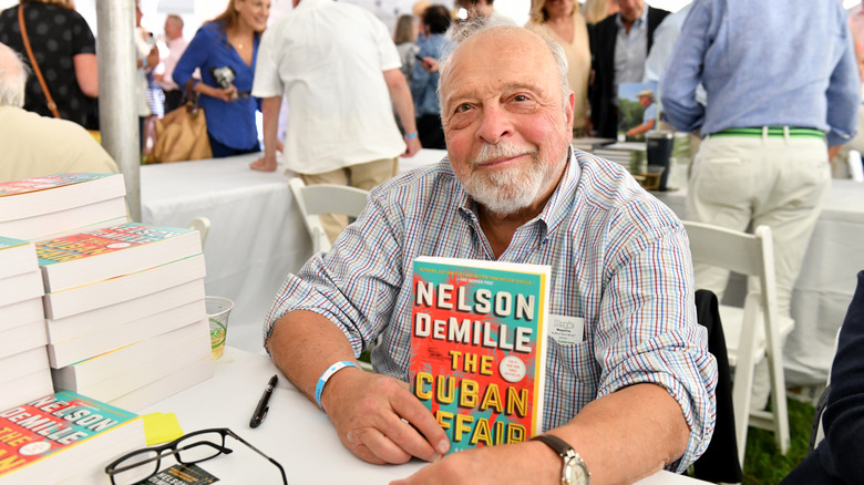 Nelson DeMille sitting at a book signing