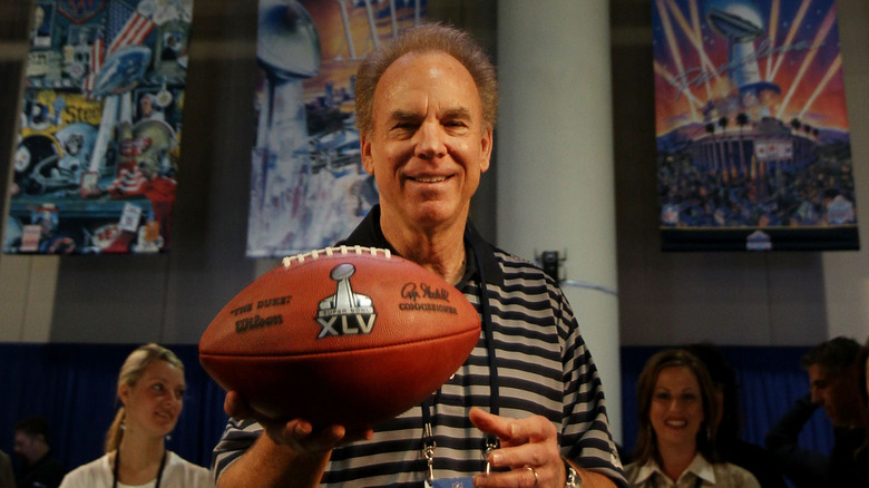 Roger Staubach holding an official Super Bowl football