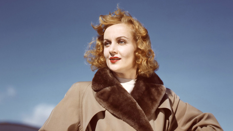 Carole Lombard outside in a fur-edged coat