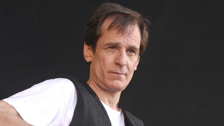 Alex Chilton on stage looking into crowd