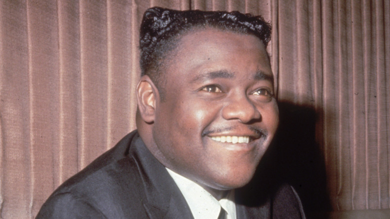 Fats Domino with flattop smiling and looking up