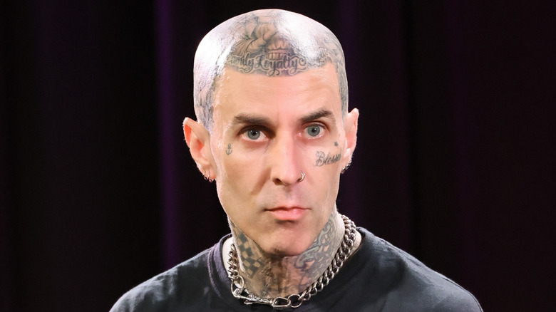 Travis Barker staring out seriously