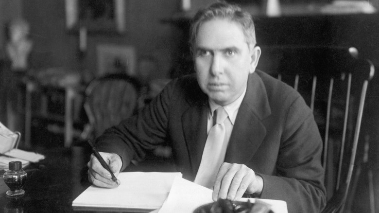 Theodore Dreiser writing at desk