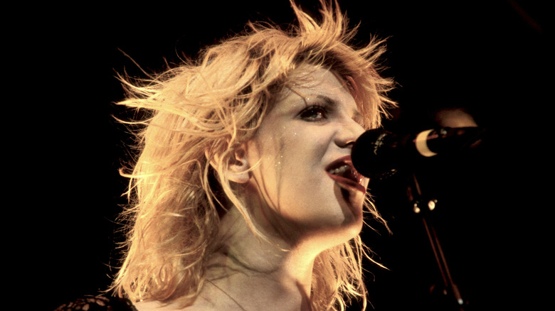 Courtney Love singing into microphone