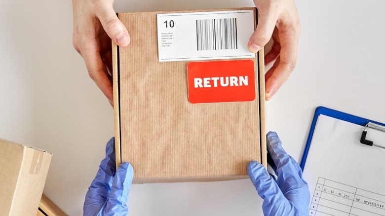 workers holding brown box