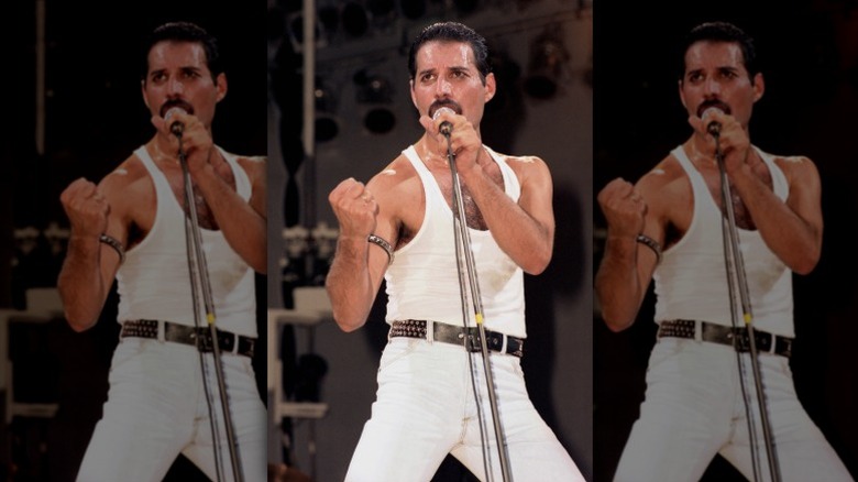 freddie mercury in tank top singing on stage