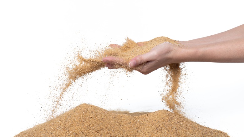 Woman tossing sand
