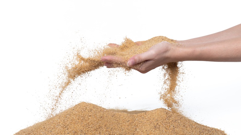 Woman tossing sand