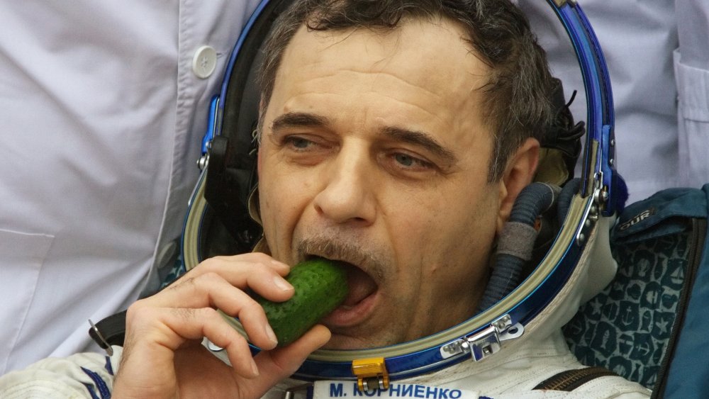 Cosmonaut eating a cucumber