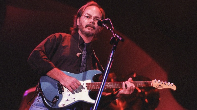 Walter Becker playing guitar onstage