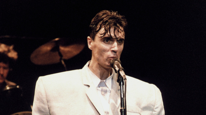 David Byrne wearing oversized white suit during Talking Heads concert