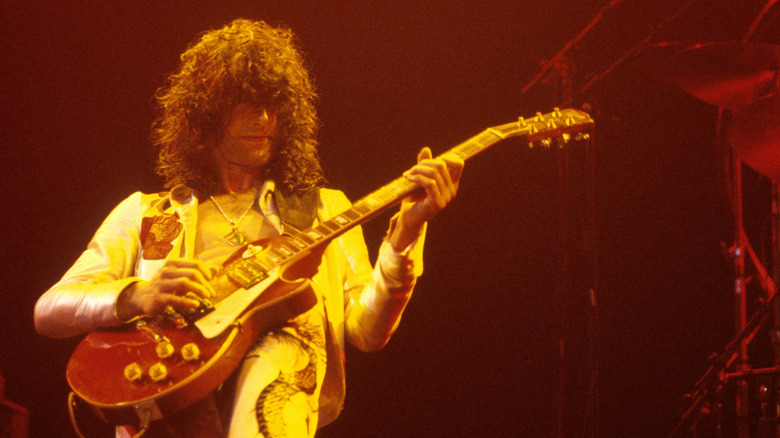 Jimmy Page playing guitar during Led Zeppelin concert