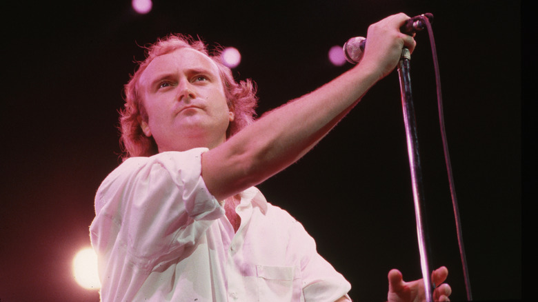 Phil Collins in concert circa 1987, wearing a white shirt