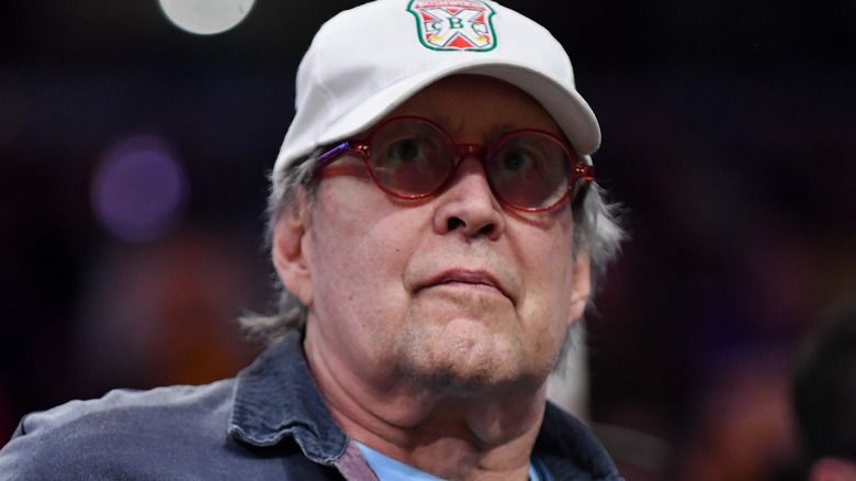 Chevy Chase in hat and glasses