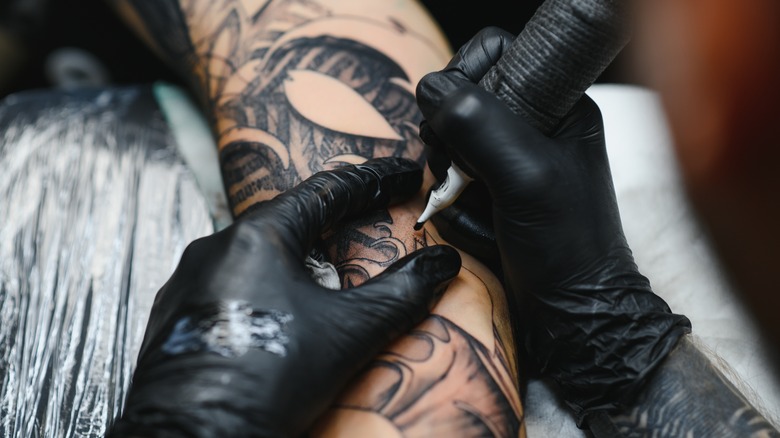 Tattoo artist working