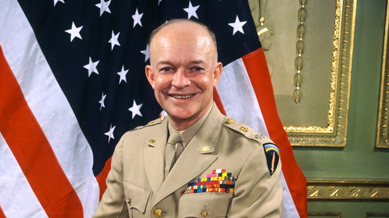 Dwight D. Eisenhower in uniform in front of the American flag