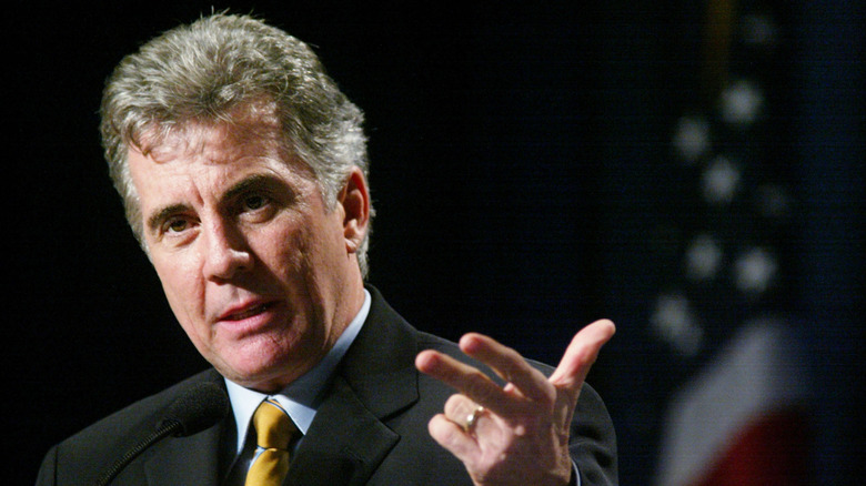 john walsh speaks on a 2002 panel