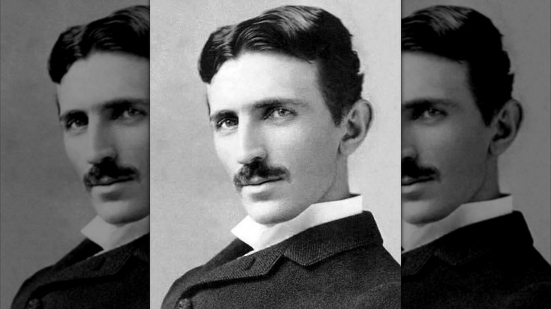 Nikola Tesla with dark suit and moustache looking left to camera