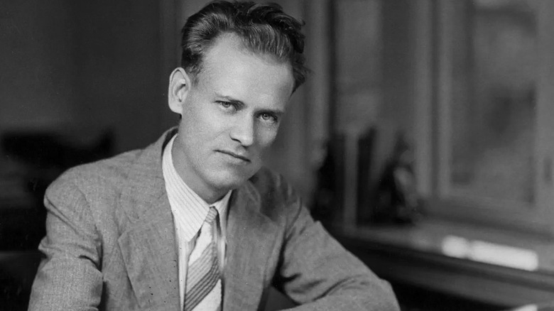 Philo Farnsworth in a light suit sat at a desk