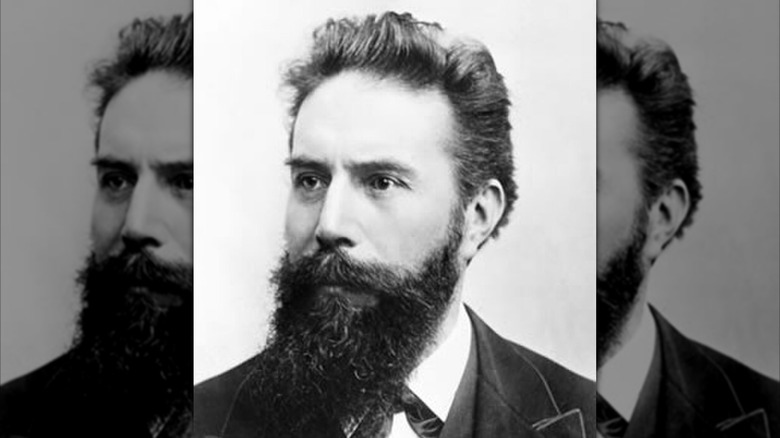 Wilhelm Rontgen with long dark beard in suit looking to his right for photo