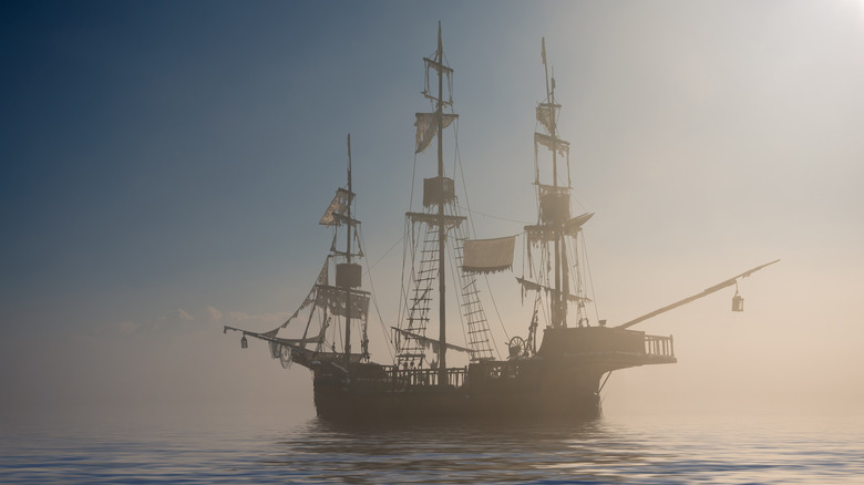 pirate ship on water fog