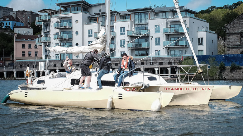 people sailing teignmouth replica building background