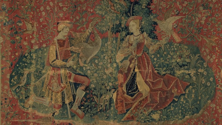 tapestry of huntsman presenting heron to a lady 