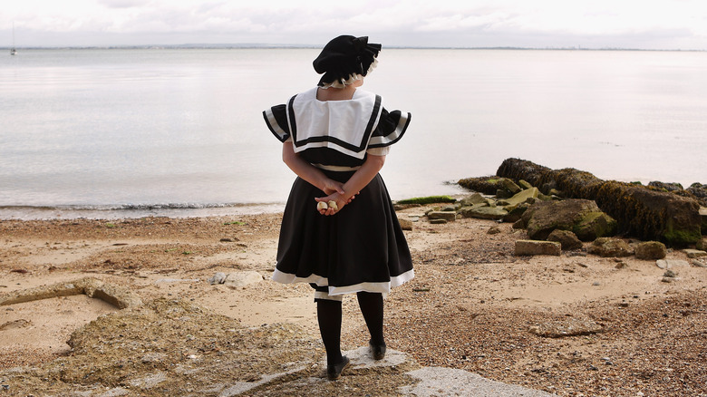 woman in victorian bathing costume on beach