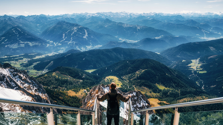 Hiker surveying vast mountainscape