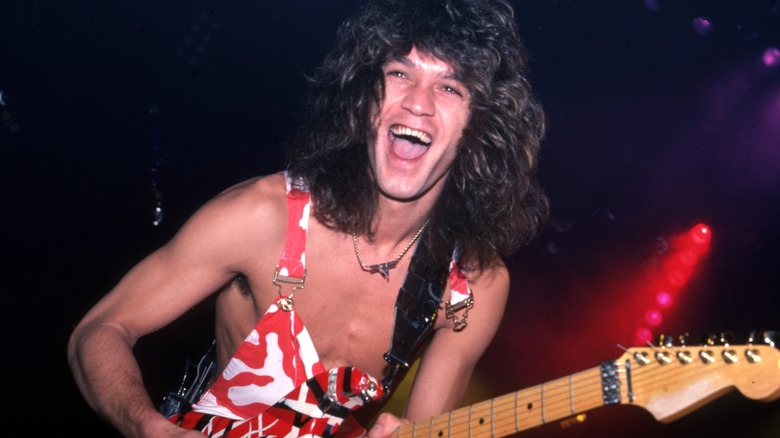 Eddie Van Halen smiling with guitar