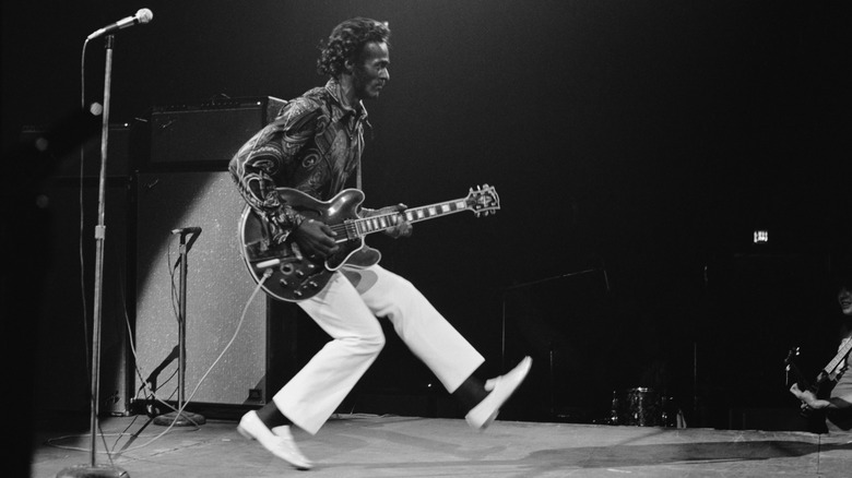 Chuck Berry dancing and playing guitar
